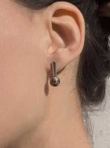 Quarry brass and stone Roos Earring, on model. Available at FAWN Toronto.